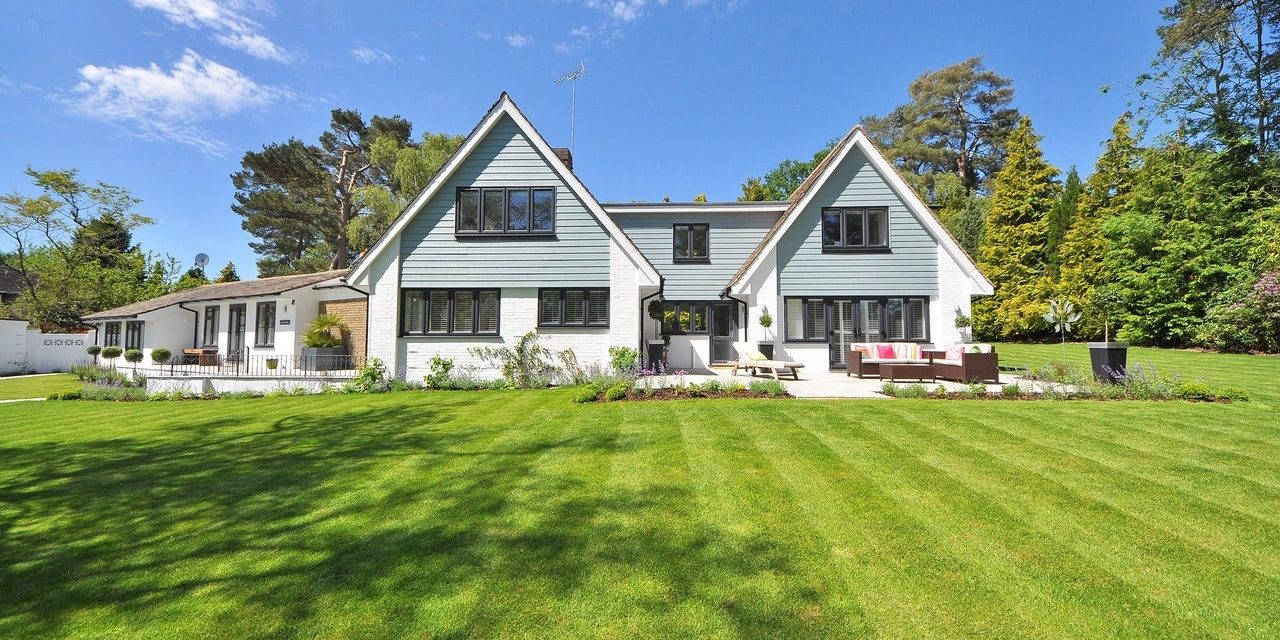 White and Gray Wooden House Near Grass Field and Trees